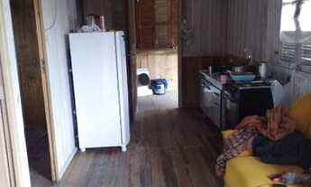 Imagem 6: Terreno com casa de madeira