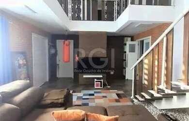 Imagem 2: Casa com 233m², 2 dormitórios sendo 1 suíte, living com lareira, espaço gourmet com churra