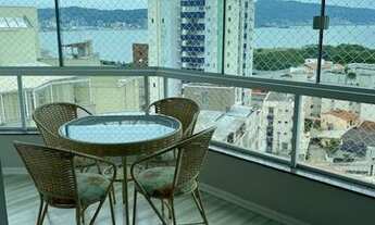 Imagem 6: Apto de frente semi mobiliado, com sala de jantar completa, painel para TV, sacada fechada