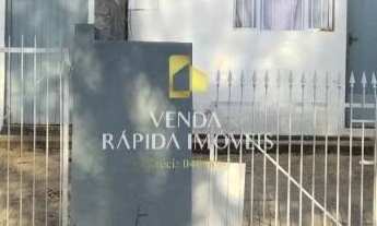 Imagem: Terreno com casas e área verde na Colonia