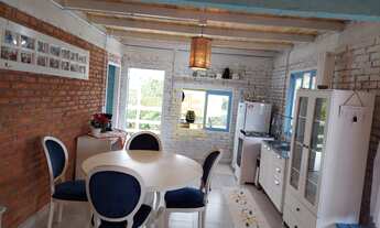 Imagem 2: Casa de tijolinho à vista cercada pela natureza em Rio dos Cedros