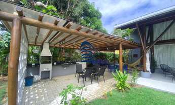 Imagem 1: Casa com arquitetura rustica, bastante madeira e vidro na sua fachada