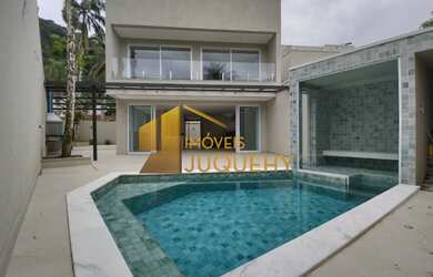 Imagem: A casa em condomínio possui 5 Dormitórios, 5 Suítes, 2 Vagas