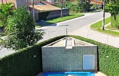 Imagem: A casa possui 5 Dormitórios, 4 Banheiros, 5 Vagas na garagem