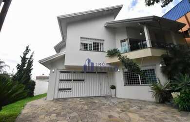 Imagem: A casa possui 5 Dormitórios, 4 Banheiros, 5 Vagas na garagem