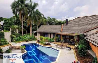 Imagem: A casa possui 5 Dormitórios, 5 Banheiros, 5 Vagas na garagem