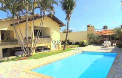 Imagem: A casa possui 3 Dormitórios, 4 Banheiros, 5 Vagas na garagem