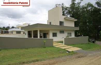 Imagem 8: Sobrado a venda no Ninho Verde, frente ao asfalto e lago do condomínio...