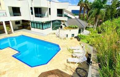 Imagem: A casa possui 4 Dormitórios, 5 Banheiros, 5 Vagas na garagem