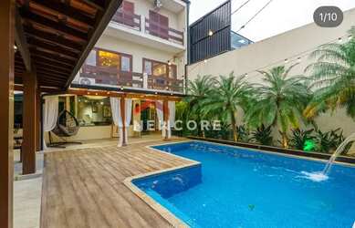 Imagem: A casa possui 4 Dormitórios, 4 Banheiros, 4 Vagas na garagem