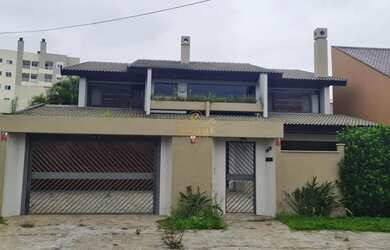 Imagem: A casa possui 4 Dormitórios, 5 Banheiros, 4 Vagas na garagem