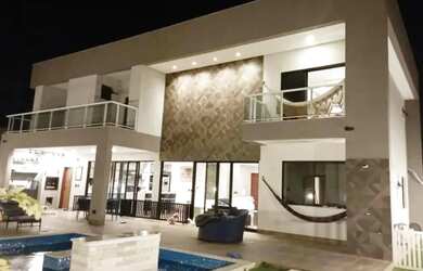 Imagem: A casa possui 5 Dormitórios, 5 Banheiros, 4 Vagas na garagem