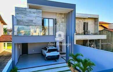 Imagem: A casa possui 4 Dormitórios, 5 Banheiros, 4 Vagas na garagem