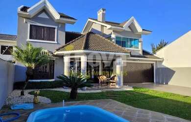 Imagem: A casa possui 4 Dormitórios, 4 Banheiros, 2 Vagas na garagem