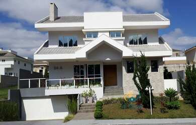 Imagem: A casa em condomínio possui 4 Dormitórios, 5 Banheiros, 2