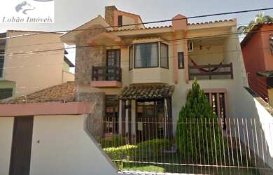 Imagem: A casa possui 3 Dormitórios, 3 Banheiros, 2 Vagas na garagem