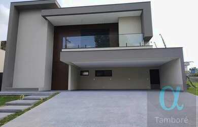 Imagem: A casa possui 4 Dormitórios, 5 Banheiros, 5 Vagas na garagem