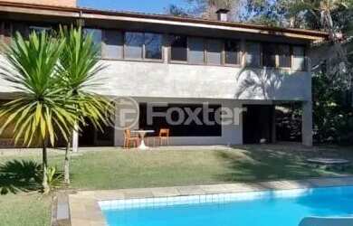 Imagem: A casa possui 4 Dormitórios, 5 Banheiros, 5 Vagas na garagem