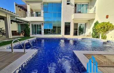 Imagem: A casa possui 4 Dormitórios, 5 Banheiros, 3 Vagas na garagem