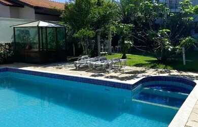 Imagem: A casa possui 4 Dormitórios, 3 Banheiros, 5 Vagas na garagem