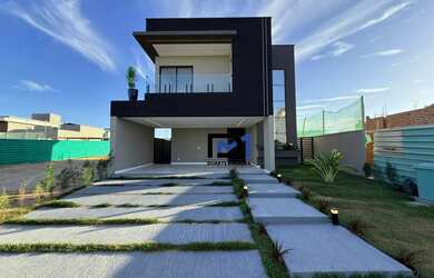 Imagem: A casa possui 4 Dormitórios, 5 Banheiros, 4 Vagas na garagem