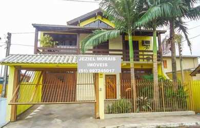 Imagem: A casa possui 5 Dormitórios, 4 Banheiros, 4 Vagas na garagem