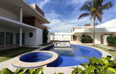 Imagem: A casa possui 4 Dormitórios, 5 Banheiros, 5 Vagas na garagem