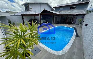 Imagem: A casa possui 4 Dormitórios, 5 Banheiros, 2 Vagas na garagem