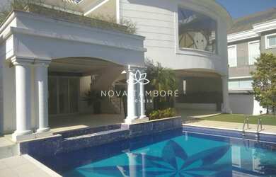 Imagem: A casa possui 4 Dormitórios, 5 Banheiros, 4 Vagas na garagem