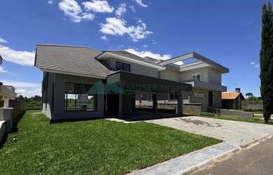 Imagem: A casa possui 3 Dormitórios, 5 Banheiros, 3 Vagas na garagem