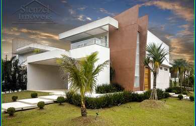 Imagem: A casa em condomínioe possui 4 Dormitórios, 5 Banheiros, 4