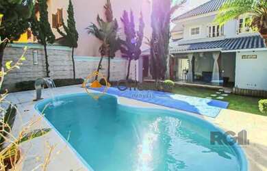 Imagem: A casa possui 3 Dormitórios, 5 Banheiros, 4 Vagas na garagem