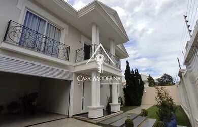 Imagem: A casa possui 3 Dormitórios, 5 Banheiros, 4 Vagas na garagem