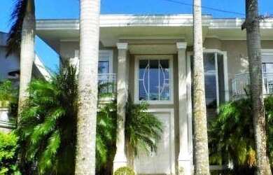 Imagem: A casa possui 5 Dormitórios, 5 Banheiros, 4 Vagas na garagem