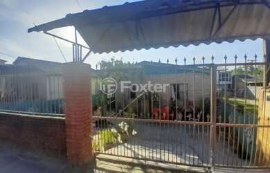 Imagem: A casa possui 5 Dormitórios, 2 Banheiros, 4 Vagas na garagem