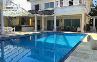 Imagem: A casa possui 5 Dormitórios, 5 Banheiros, 4 Vagas na garagem