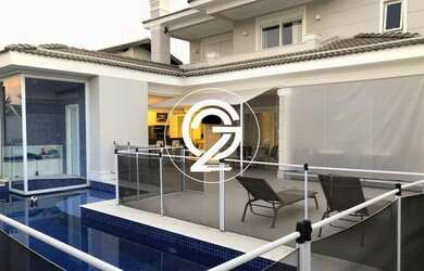 Imagem: A casa possui 4 Dormitórios, 5 Banheiros, 4 Vagas na garagem