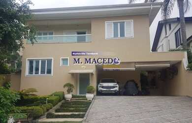 Imagem: A casa possui 4 Dormitórios, 5 Banheiros, 4 Vagas na garagem