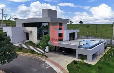 Imagem: A casa possui 4 Dormitórios, 4 Banheiros, 5 Vagas na garagem