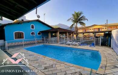 Imagem: A casa possui 5 Dormitórios, 2 Banheiros, 5 Vagas na garagem