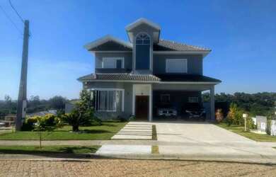 Imagem: A casa possui 4 Dormitórios, 5 Banheiros, 5 Vagas na garagem