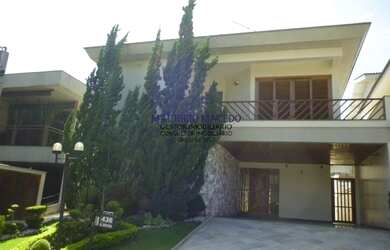 Imagem: A casa possui 3 Dormitórios, 5 Banheiros, 4 Vagas na garagem