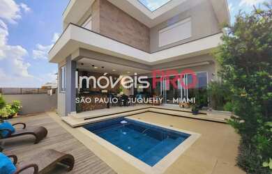 Imagem: A casa em condomínio e possui 3 Dormitórios, Suítes, 5 Banheiros