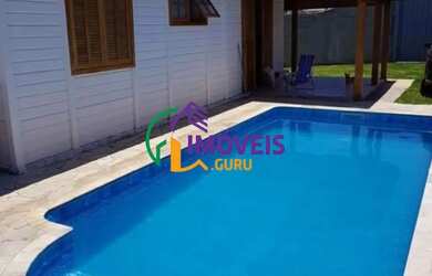 Imagem: A casa possui 4 Dormitórios, 2 Banheiros, 5 Vagas na garagem