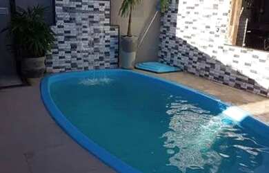 Imagem: A casa possui 4 Dormitórios, 2 Vagas na garagem e está localizado