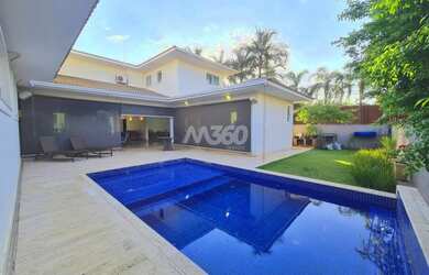 Imagem: A casa possui 4 Dormitórios, 5 Banheiros, 4 Vagas na garagem