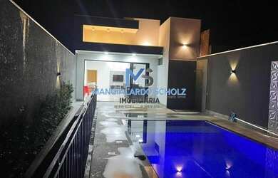 Imagem: A casa possui 4 Dormitórios, 5 Banheiros, 2 Vagas na garagem