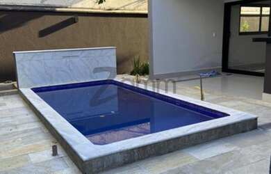 Imagem: A casa possui 3 Dormitórios, 5 Banheiros, 5 Vagas na garagem