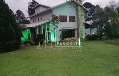 Imagem: A casa possui 4 Dormitórios, 4 Banheiros, 4 Vagas na garagem