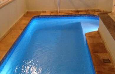 Imagem: A casa possui 4 Dormitórios, 2 Banheiros, 4 Vagas na garagem